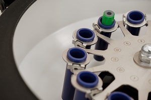 Lab centrifuge spinning to shake a variety of sample bottles