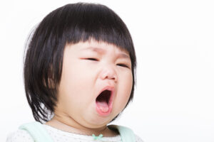 Asian-American baby girl coughing